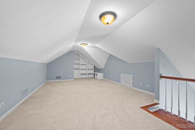 bonus room featuring visible vents, carpet flooring, baseboards, and lofted ceiling