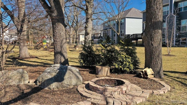 view of yard with a deck, a fire pit, and a residential view