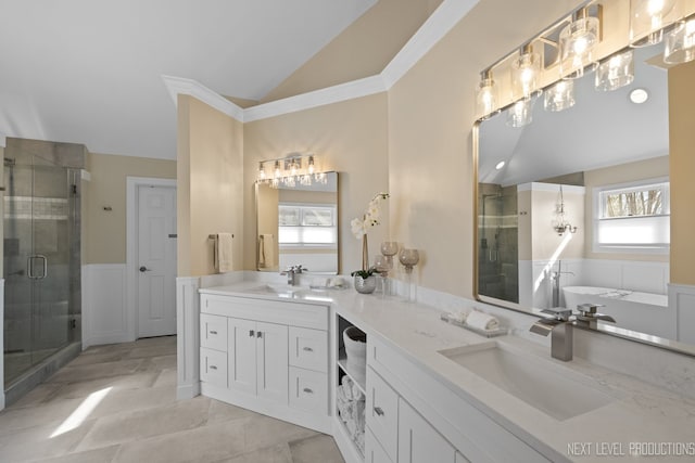 bathroom featuring a stall shower, lofted ceiling, and a sink