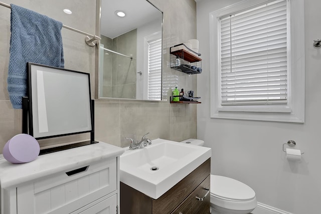 full bath with tasteful backsplash, toilet, vanity, and walk in shower