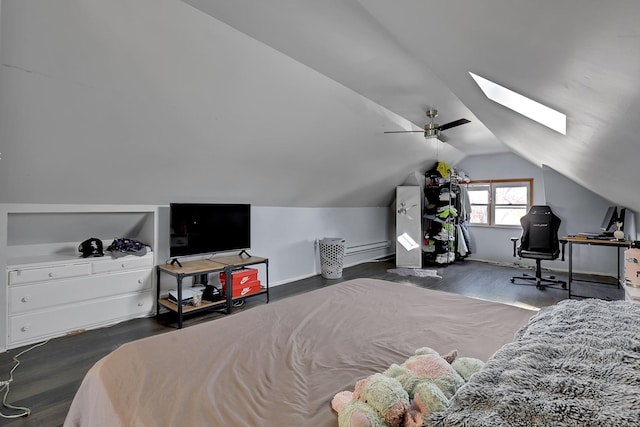 bedroom with lofted ceiling with skylight, wood finished floors, baseboards, and ceiling fan