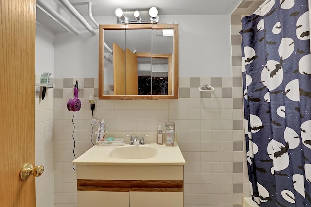 bathroom with vanity, tile walls, and a shower with curtain