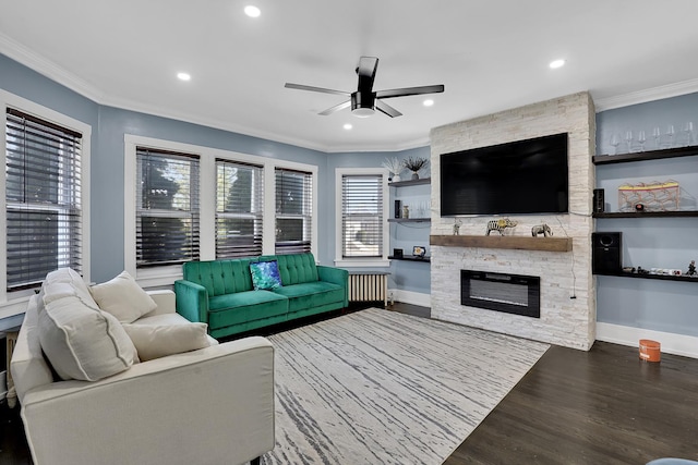 living area featuring wood finished floors, radiator heating unit, a ceiling fan, and ornamental molding