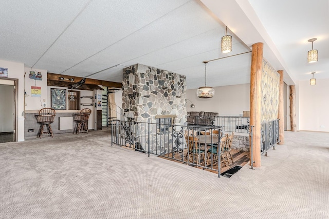 living room featuring carpet flooring and a bar