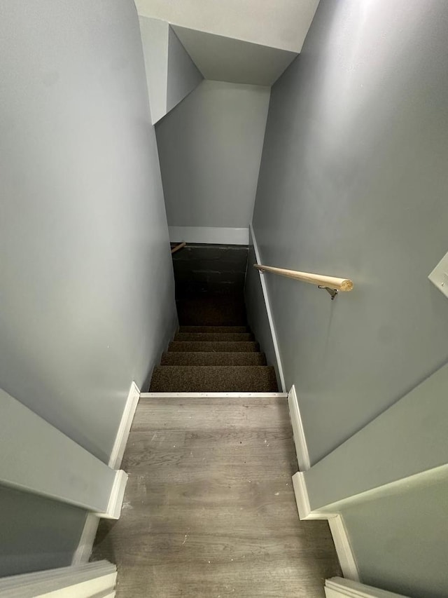 staircase featuring wood finished floors