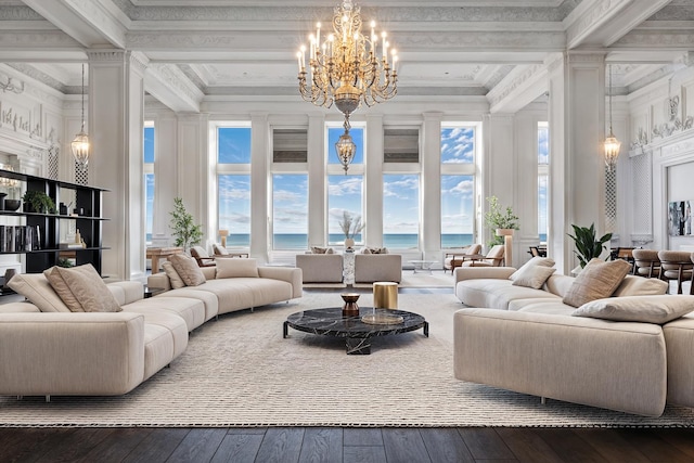 living room featuring ornamental molding, hardwood / wood-style flooring, coffered ceiling, a high ceiling, and an inviting chandelier