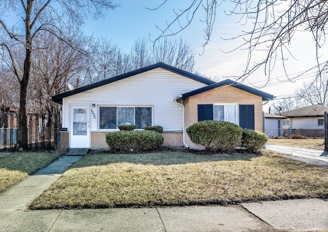 bungalow with brick siding, a front yard, and fence