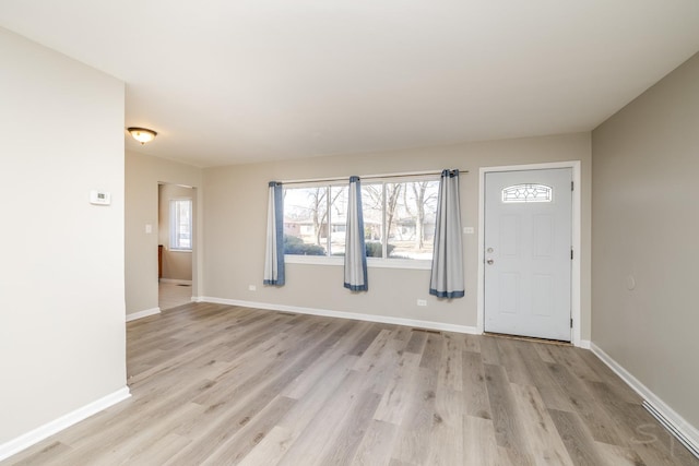 entryway featuring baseboards and light wood-style floors