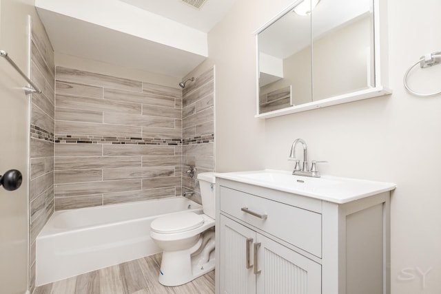 bathroom featuring visible vents, toilet, shower / washtub combination, and vanity