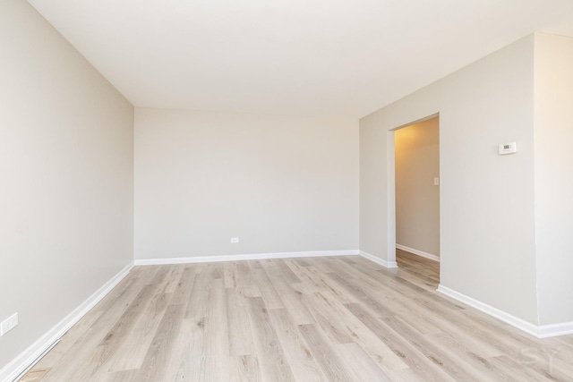 unfurnished room with light wood-style floors and baseboards