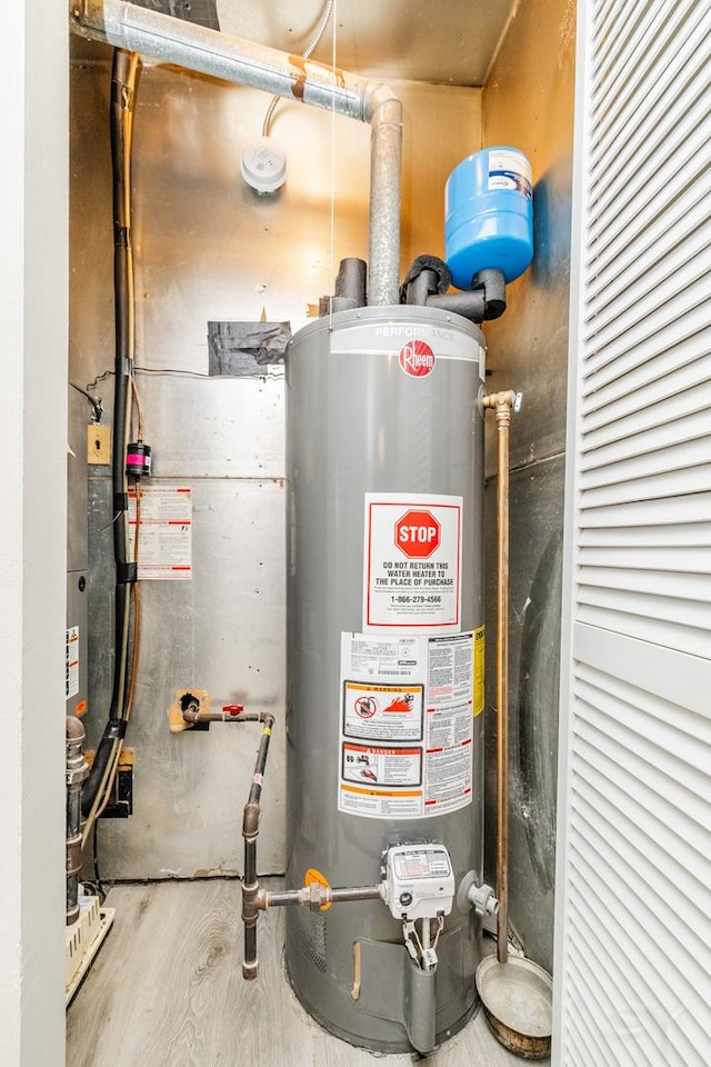 utility room featuring water heater