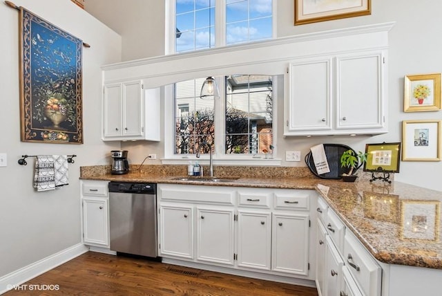 kitchen featuring a sink, dishwasher, white cabinets, and a healthy amount of sunlight