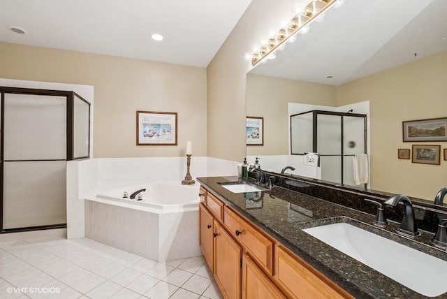 bathroom with a sink, a bath, a shower stall, and tile patterned flooring