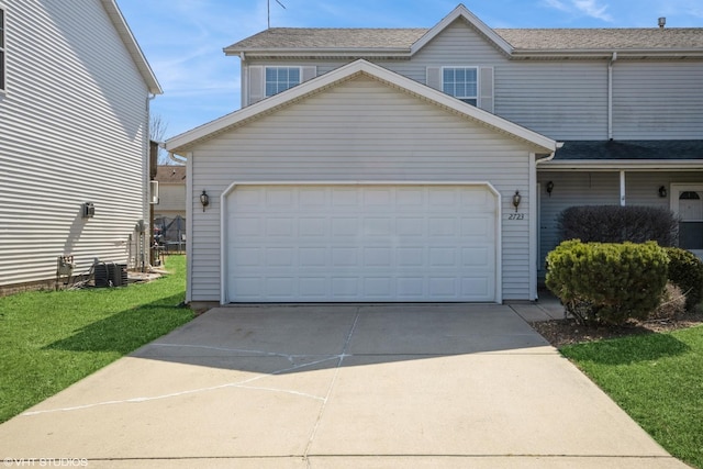 exterior space with a front yard, a garage, and driveway