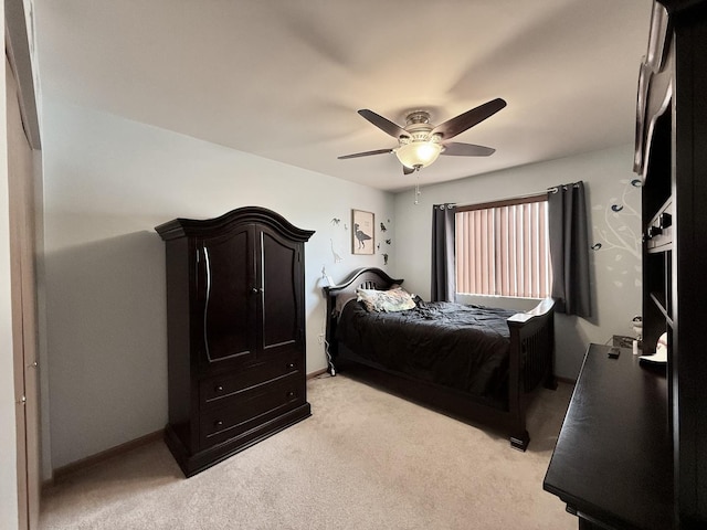 bedroom featuring baseboards, light carpet, and ceiling fan