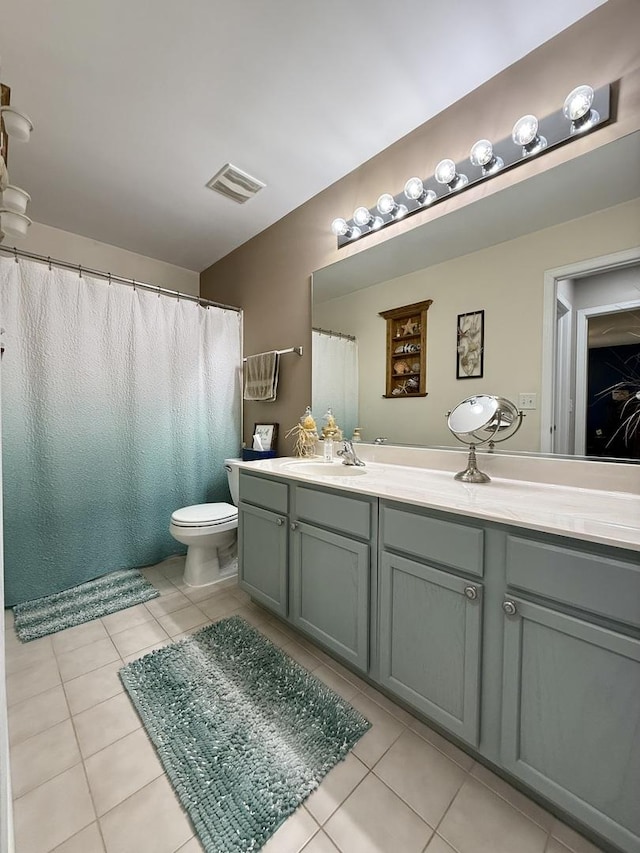 full bath featuring vanity, tile patterned floors, toilet, and visible vents