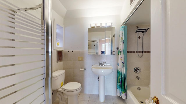 full bathroom featuring tile patterned flooring, toilet, tile walls, and shower / bath combo