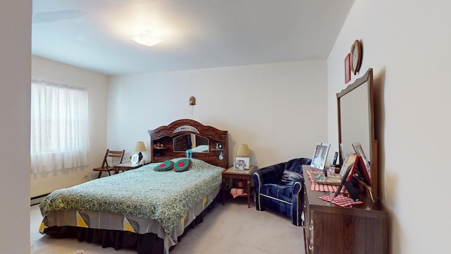 bedroom with a baseboard radiator and light carpet