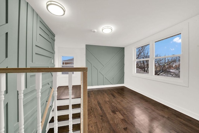 interior space with stairway, baseboards, and dark wood finished floors