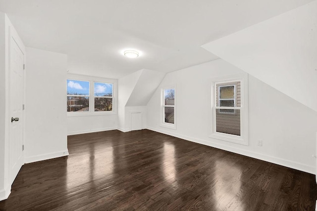 bonus room featuring vaulted ceiling, wood finished floors, and baseboards