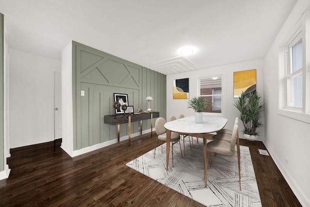 dining room with visible vents, baseboards, and dark wood-style flooring