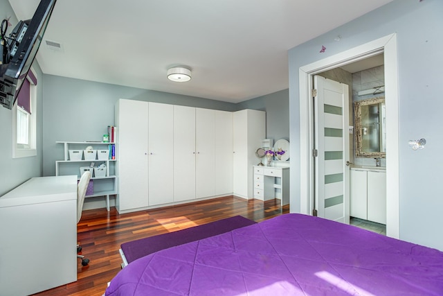 bedroom with visible vents and wood finished floors