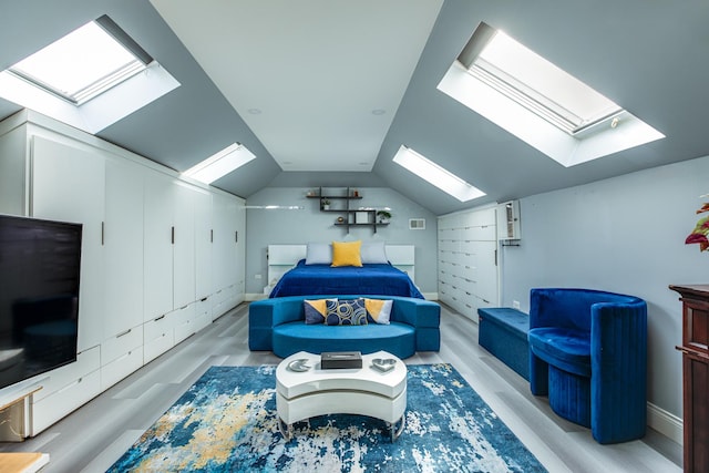 bedroom featuring lofted ceiling, visible vents, and light wood finished floors