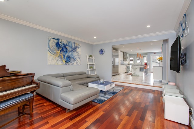 living area with hardwood / wood-style floors, recessed lighting, and ornamental molding