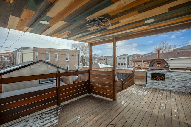 wooden terrace with a ceiling fan and a residential view