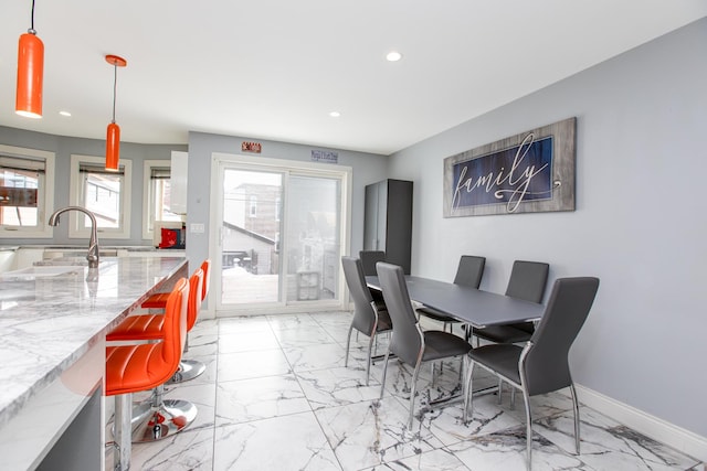 dining space with recessed lighting, baseboards, and marble finish floor