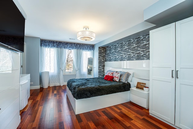 bedroom with visible vents and dark wood-style floors