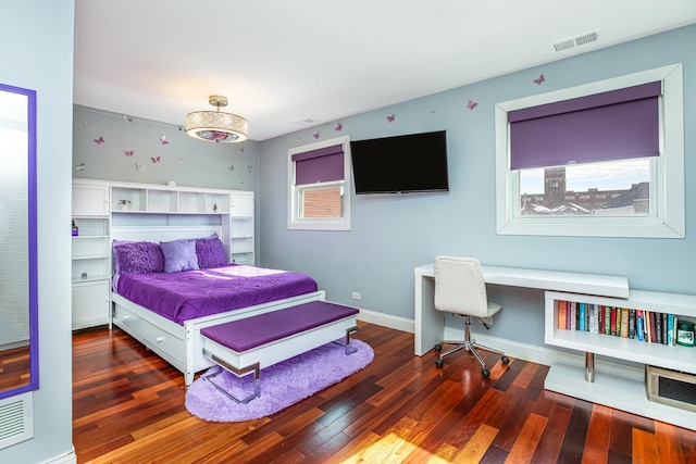 bedroom featuring hardwood / wood-style floors, baseboards, and visible vents