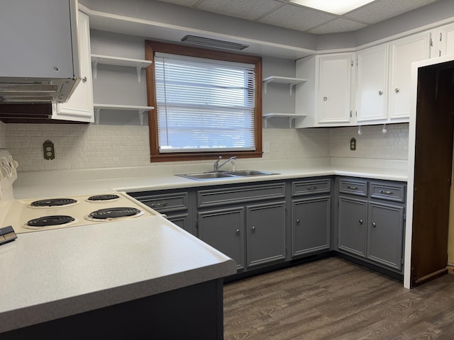 kitchen featuring a sink, gray cabinets, electric range, and open shelves