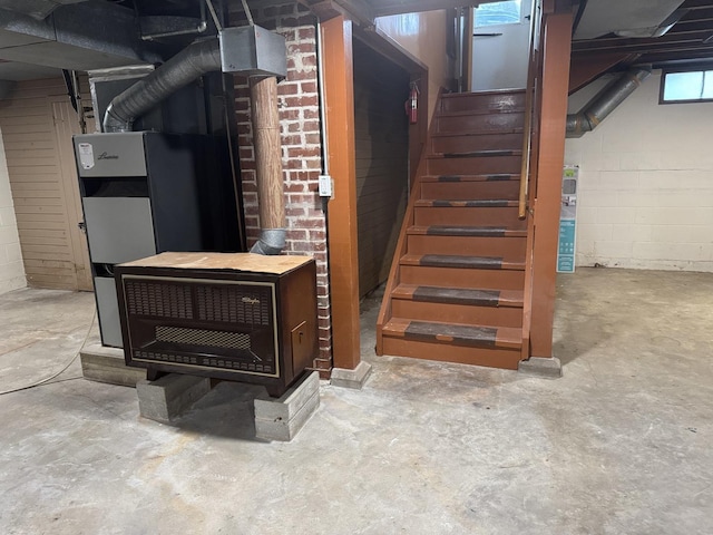 basement with stairway and concrete block wall