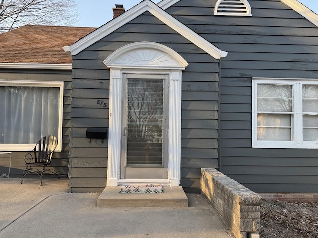 property entrance featuring a chimney