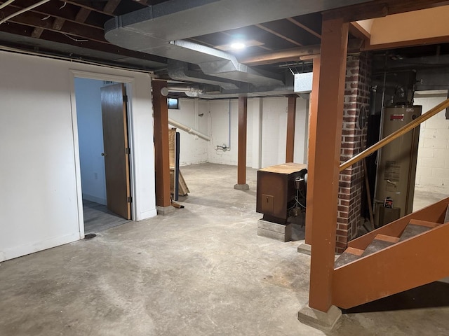 unfinished basement featuring stairs and gas water heater