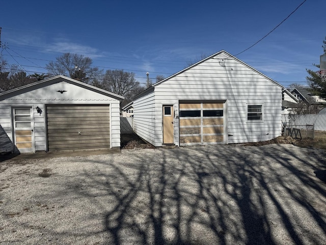 detached garage featuring fence