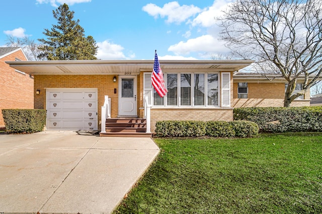 view of front of property with brick siding, driveway, a front yard, and a garage