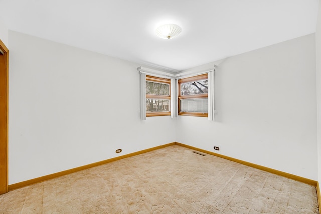 spare room with visible vents and baseboards