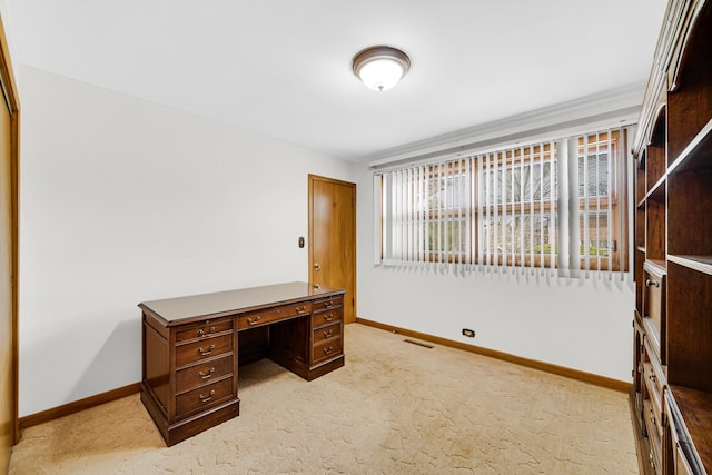 office featuring visible vents, light colored carpet, and baseboards