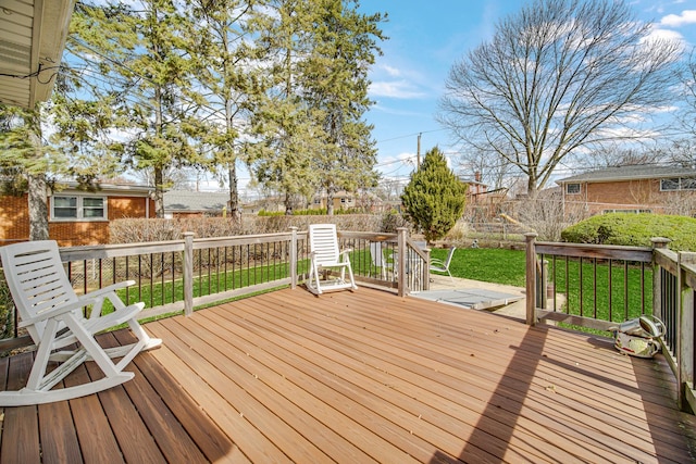 wooden terrace featuring a yard