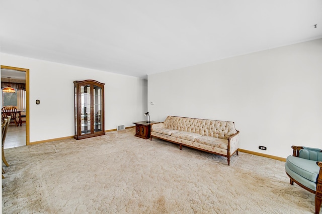 sitting room featuring visible vents, baseboards, and carpet flooring