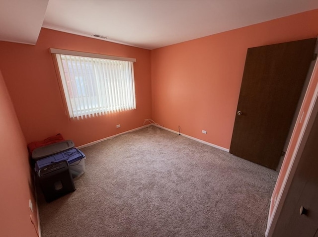 unfurnished bedroom featuring carpet flooring, baseboards, and visible vents