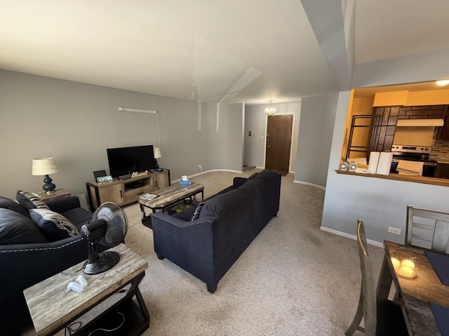 carpeted living area with an inviting chandelier and baseboards