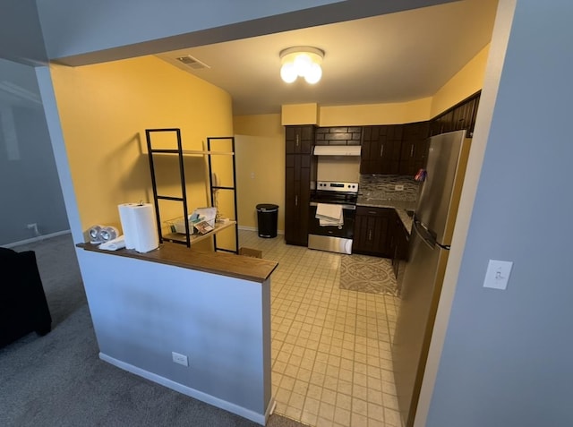 kitchen featuring visible vents, dark brown cabinets, under cabinet range hood, appliances with stainless steel finishes, and backsplash