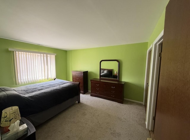 carpeted bedroom featuring baseboards