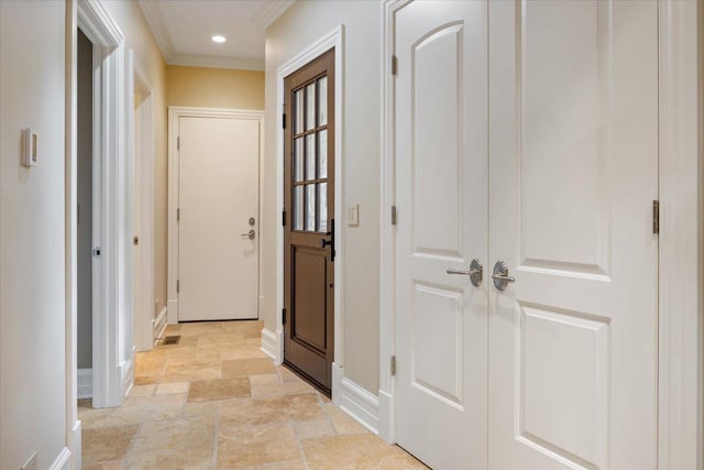 corridor featuring recessed lighting, stone finish flooring, baseboards, and ornamental molding