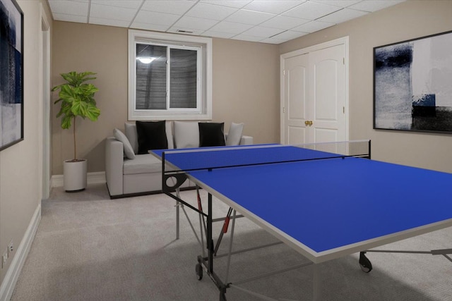 recreation room featuring a paneled ceiling, baseboards, and carpet floors