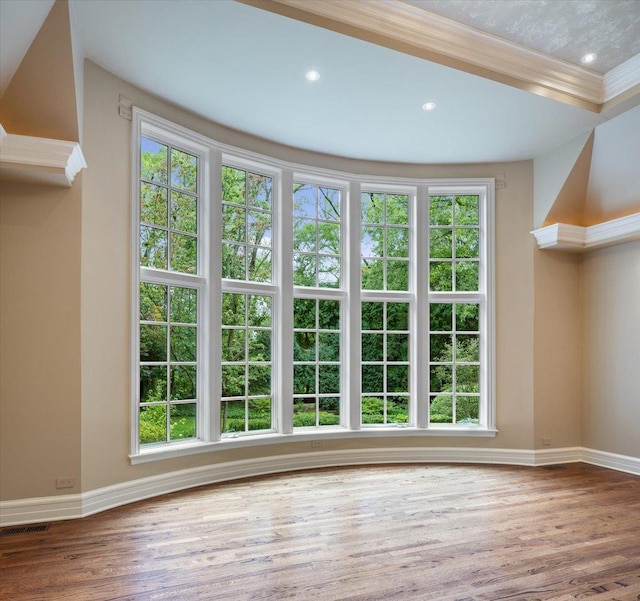 unfurnished living room with plenty of natural light and wood finished floors