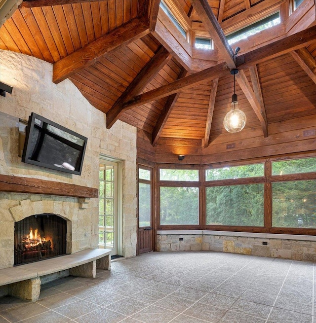 unfurnished living room with beam ceiling, wooden ceiling, high vaulted ceiling, and a fireplace